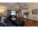 Cozy living room featuring hardwood floors, a ceiling fan, and comfortable seating at 11416 Wellman Dr, Riverview, FL 33578