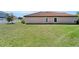Expansive lawn in the backyard with views of the home's exterior at 12055 Cardinal Flower Dr, Riverview, FL 33579