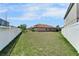 Spacious fenced backyard with a lush green lawn, offering privacy at 12055 Cardinal Flower Dr, Riverview, FL 33579