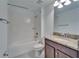 Bathroom features a shower-tub combo, granite vanity, and tile flooring at 12055 Cardinal Flower Dr, Riverview, FL 33579