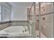 Bathroom featuring a standalone tub and shower with neutral-colored tile at 12055 Cardinal Flower Dr, Riverview, FL 33579