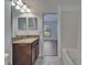 Bathroom featuring granite countertops, tiled floors, and view to bedroom entrance at 12055 Cardinal Flower Dr, Riverview, FL 33579