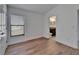 Bedroom features wood-look flooring and a window bringing in natural light at 12055 Cardinal Flower Dr, Riverview, FL 33579