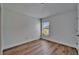 White bedroom with hardwood floors, a window, and white trim at 12055 Cardinal Flower Dr, Riverview, FL 33579