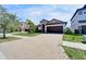 Charming home featuring a tile roof, well-manicured lawn, and a paved driveway leading to a two-car garage at 12055 Cardinal Flower Dr, Riverview, FL 33579