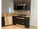 Modern kitchen with stainless steel appliances, granite countertops, dark wood cabinetry and a decorative backsplash at 12055 Cardinal Flower Dr, Riverview, FL 33579