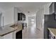 Eat-in kitchen featuring granite countertops, a breakfast bar, dark cabinets, and stainless steel appliances at 12055 Cardinal Flower Dr, Riverview, FL 33579