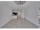 Open-concept living room with tile floors, white walls, and ceiling fan at 12055 Cardinal Flower Dr, Riverview, FL 33579
