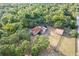 Stunning aerial view of a spacious property, showcasing a home with a pool, a barn, and lush greenery at 12311 Oakwood Dr, Hudson, FL 34669