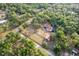 Aerial shot captures a sprawling estate with a well-maintained home, barn, and refreshing pool surrounded by nature at 12311 Oakwood Dr, Hudson, FL 34669
