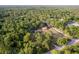 Aerial view showcases a luxurious home with a pool, barn and verdant surroundings, providing a tranquil retreat at 12311 Oakwood Dr, Hudson, FL 34669