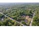 Serene aerial shot of a home nestled in a lush, green landscape, featuring a barn, pool, and a large yard at 12311 Oakwood Dr, Hudson, FL 34669