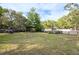 Expansive backyard with green grass and a shed, offering space for outdoor activities at 12311 Oakwood Dr, Hudson, FL 34669