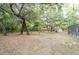 Backyard showcasing a screened-in pool area and trees at 12311 Oakwood Dr, Hudson, FL 34669
