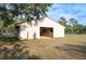 Spacious barn for livestock or storage, surrounded by lush greenery and fenced pastures at 12311 Oakwood Dr, Hudson, FL 34669