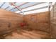 Interior of a barn with wooden walls and a dirt floor, ideal for sheltering animals at 12311 Oakwood Dr, Hudson, FL 34669