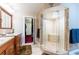 Bright bathroom showcasing a glass shower enclosure and a glimpse into the walk-in closet at 12311 Oakwood Dr, Hudson, FL 34669