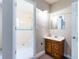 Bathroom with tiled shower, toilet, and wood vanity at 12311 Oakwood Dr, Hudson, FL 34669