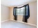 Bedroom featuring tile flooring and window with decorative sheer and blackout curtains at 12311 Oakwood Dr, Hudson, FL 34669
