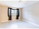 Neutral bedroom featuring tile flooring and a window with dark curtains at 12311 Oakwood Dr, Hudson, FL 34669