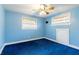 Bright blue bedroom featuring a ceiling fan and window at 12311 Oakwood Dr, Hudson, FL 34669