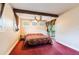 Cozy bedroom featuring a unique ceiling with wood beam and a door to the outside porch at 12311 Oakwood Dr, Hudson, FL 34669