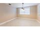 This dining room features tile floors, neutral walls, and a window to allow plenty of natural light at 12311 Oakwood Dr, Hudson, FL 34669