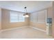 This dining room features tile floors, neutral walls, and a window to allow plenty of natural light at 12311 Oakwood Dr, Hudson, FL 34669