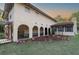 Charming stucco home boasting arched loggia, landscape beds, and a covered entry for welcoming curb appeal at 12311 Oakwood Dr, Hudson, FL 34669