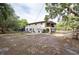 Rear view of property features a balcony, covered patio, and an expansive yard at 12311 Oakwood Dr, Hudson, FL 34669