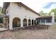 Charming home exterior features stucco siding, a red tile roof, and a covered porch with arched openings at 12311 Oakwood Dr, Hudson, FL 34669