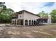 Back of home with a pergola, covered patio, and lush landscaping at 12311 Oakwood Dr, Hudson, FL 34669