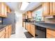 This kitchen includes wooden cabinets, stainless steel appliances, and tiled backsplash at 12311 Oakwood Dr, Hudson, FL 34669