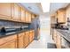 This kitchen includes wooden cabinets, stainless steel appliances, and tiled backsplash at 12311 Oakwood Dr, Hudson, FL 34669