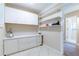 Functional laundry room with ample storage cabinets and shelving at 12311 Oakwood Dr, Hudson, FL 34669