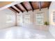 Cozy living space with wood-beamed ceilings and ample natural light from the surrounding windows at 12311 Oakwood Dr, Hudson, FL 34669