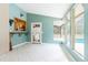 Bright living area with tile flooring, wet bar, and windows offering a view of the pool at 12311 Oakwood Dr, Hudson, FL 34669