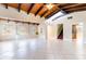 Bright living room with vaulted ceilings, wood beams, stone fireplace, and a staircase at 12311 Oakwood Dr, Hudson, FL 34669