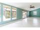 Bright living area with tile flooring and large windows offering views of the screened in lanai at 12311 Oakwood Dr, Hudson, FL 34669