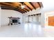 Spacious living room with a stone fireplace and beautiful wood beamed vaulted ceilings at 12311 Oakwood Dr, Hudson, FL 34669