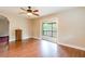 Spacious living area with laminate floors and sliding doors that let in natural light at 12311 Oakwood Dr, Hudson, FL 34669