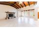 Spacious living room showcasing vaulted wood beam ceilings and a charming stone fireplace at 12311 Oakwood Dr, Hudson, FL 34669