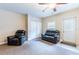 Carpeted living room features a recliner, loveseat, closet and exterior door at 12311 Oakwood Dr, Hudson, FL 34669