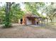 Wooden outbuilding featuring a covered porch, perfect for outdoor storage or a workshop at 12311 Oakwood Dr, Hudson, FL 34669