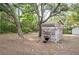 Charming wooden outbuilding with rustic accents, set within a spacious, tree-filled yard at 12311 Oakwood Dr, Hudson, FL 34669
