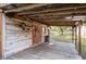 Rustic wooden outbuilding featuring a covered porch and barrel, enhancing the property's character at 12311 Oakwood Dr, Hudson, FL 34669