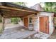 Quaint wooden outbuilding featuring a covered porch with a barrel, adding a touch of rustic charm at 12311 Oakwood Dr, Hudson, FL 34669