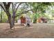 Rustic outbuildings add charm to this rural property with mature trees and a fenced yard at 12311 Oakwood Dr, Hudson, FL 34669