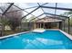 Take a dip in this brilliant blue pool surrounded by a screened-in enclosure at 12311 Oakwood Dr, Hudson, FL 34669