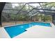 Relax by the pool in the screened enclosure while enjoying the scenery from this property at 12311 Oakwood Dr, Hudson, FL 34669